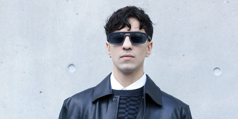 Italian singer Tedua was seen wearing matte black Emporio Armani EA4240U 5017/87 sunglasses with blue lenses at the Emporio Armani FallWinter 2026 fashion show during Milan Fashion Week.