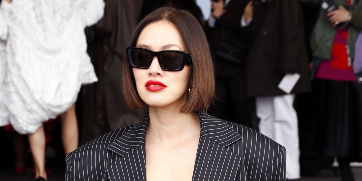 Tiffany Hsu of MyTheresa was seen wearing black Prada PR 08YS 1AB5S0 Symbole butterfly Sunglasses at the Prada Fall/Winter 2023 fashion show during Milan Fashion Week