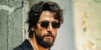 Bollywood actor Tiger Shroff was seen wearing black and ruthenium David Beckham DB 7109/S 85KIR rimless sunglasses