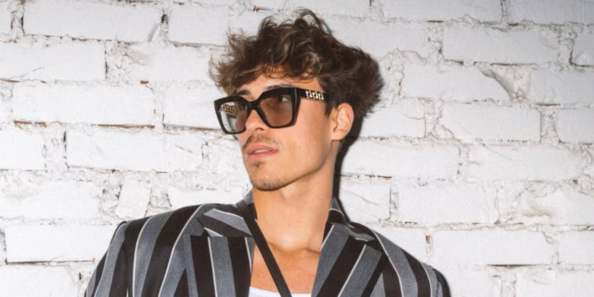 German content creator, actor, and model Tim Schaecker was seenwearing black and gold Versace 4418 GB1/87 sunglasses at the Versace Menswear Fall/Winter 2023 fashion show during Milan Men's Fashion Week