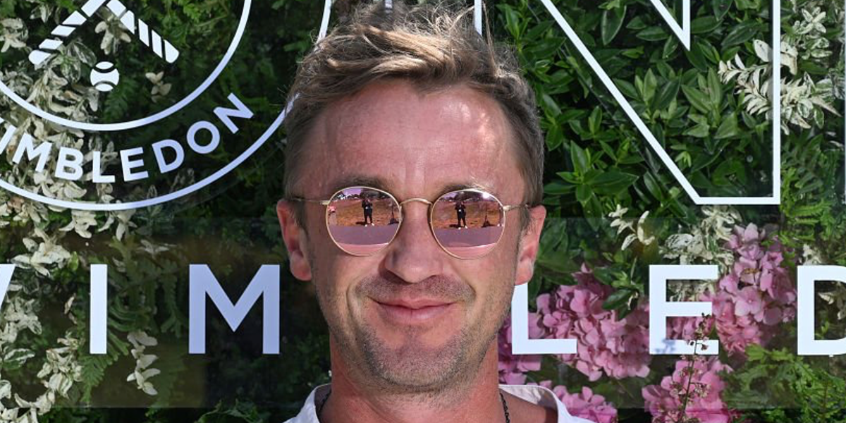 Tom Felton was seen wearing gold Ray-Ban Round Metal RB 3447 112/Z2 sunglasses with pink mirror lenses at the Wimbledon Tennis Championships 2025.
