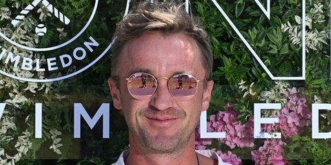 Tom Felton was seen wearing gold Ray-Ban Round Metal RB 3447 112/Z2 sunglasses with pink mirror lenses at the Wimbledon Tennis Championships 2025.