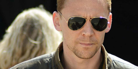 Tom Hiddleston wears Ray-Ban Aviator RB 3025 181 sunglasses on a production set