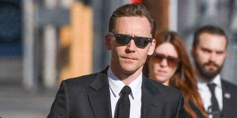 Tom Hiddleston wears Ray-Ban New Wayfarer RB 2132 901L sunglasses to an event