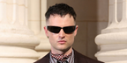 Tom Sturridge was seen wearing black Saint Laurent Sun SL 963 001 wraparound sunglasses at the Saint Laurent Menswear Spring/Summer 2027 fashion show during Paris Men's Fashion Week