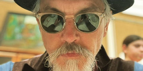 Tommy Flanagan was seen wearing transparent beige Oliver Peoples Sheldrake Sun OV5036S 1580/52 sunglasses with green lenses in his Instagram post, July 2023.