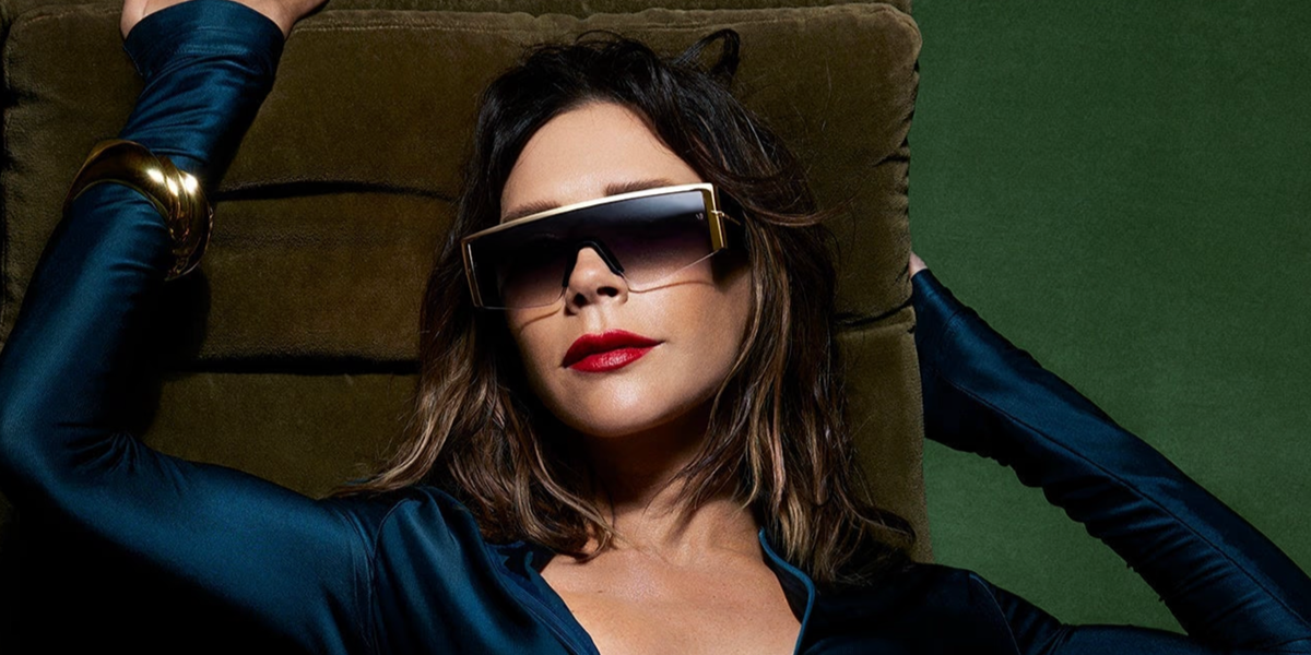 Victoria Beckham wore black and gold Victoria Beckham VB7015/S RHL/IR shield sunglasses with grey gradient lenses in the Victoria Beckham Eyewear Autumn Winter 2026 campaign.