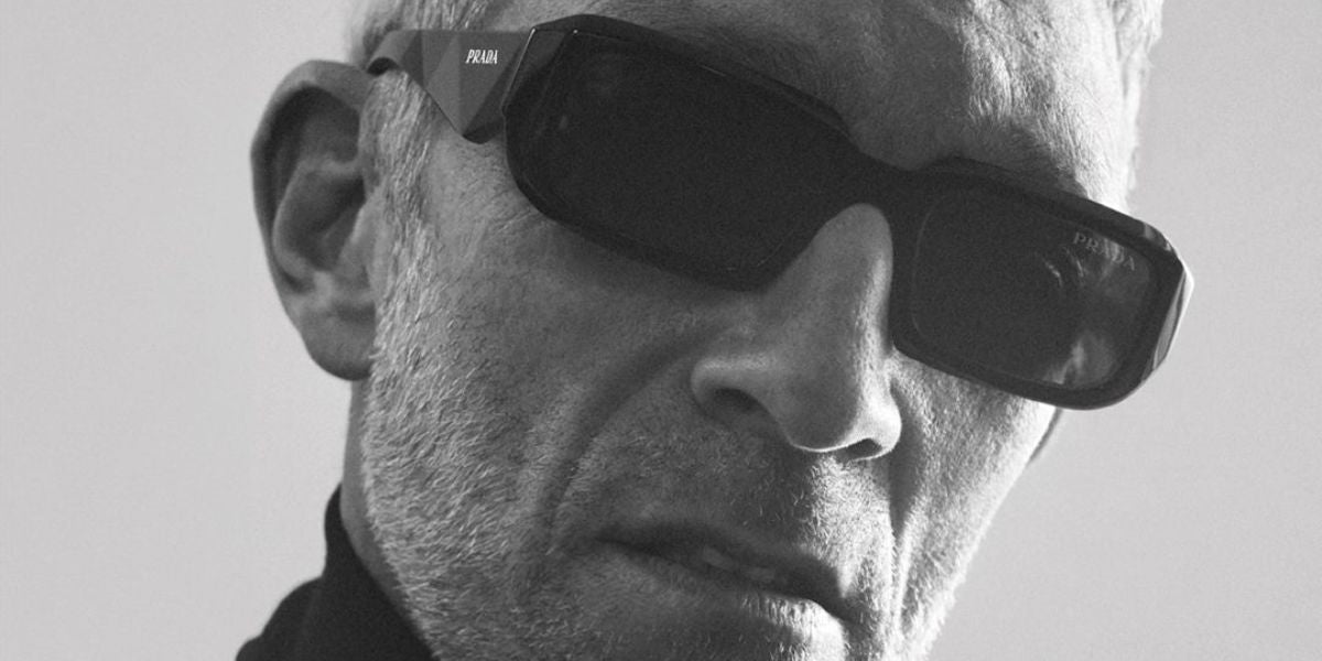 Vincent Cassel was seen modeling Prada PR 27ZS 16K08Z rectangular sunglasses in the brand's 2023 campaign