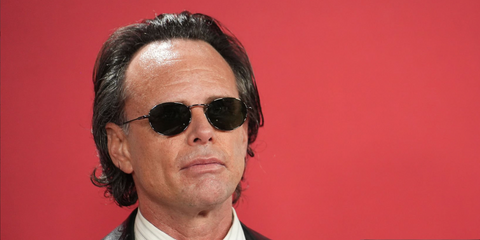 Walton Goggins was seen wearing dark ruthenium Saint Laurent SL 799 004 oval sunglasses at the GQ Men Of The Year Awards 2025