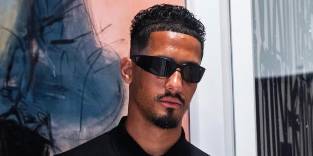 French footballer William Saliba was seen wearing black Prada PR A19S 1AB5S0 wraparound sunglasses in his Instagram post, July 2025. Shop online now on Pretavoir