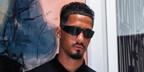 French footballer William Saliba was seen wearing black Prada PR A19S 1AB5S0 wraparound sunglasses in his Instagram post, July 2025. Shop online now on Pretavoir