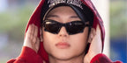South Korean singer Wooyoung of K-Pop group ATEEZ was seen wearing black Balenciaga BB0229S 001 Bat Rectangle sunglasses at Incheon Airport, March 2023.
