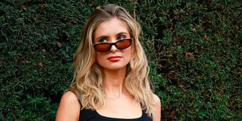 Xenia Adonts was seen wearing black Miu Miu MU A06S 16K10I sunglasses with brown lenses at the Burberry Spring/Summer 2026 fashion show during London Fashion Week. Shop online now on Pretavoir