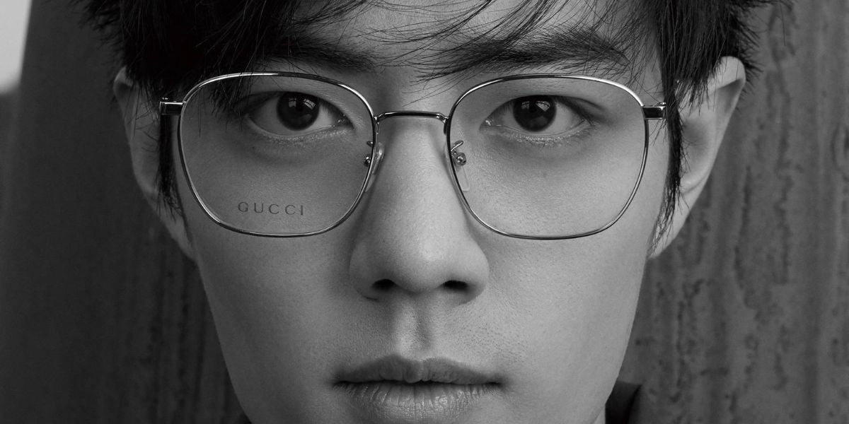 Xiao Zhan is seen wearing gold Gucci GG0681O 001 square glasses in a fashion editorial page of Vogue Me