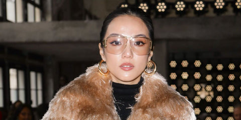 Singaporean fashion and creative force Yoyo Cao was seen wearing gold Bottega Veneta BV1065S 005 sunglasses with light yellow lenses at the Sacai Fall/Winter 2025 fashion show during Paris Fashion Week.