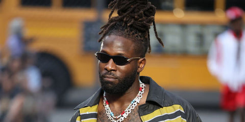 American football player Zach Pascal was seen wearing black and gold Bottega Veneta BV1390S 001 sunglasses on the runway of PDF Menswear Spring/Summer 2026 fashion show during Milan Men's Fashion Week.
