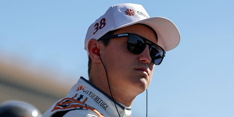 Zane Smith was seen wearing black Oakley Latch Beta OO9436 01 sunglasses with grey Prizm lenses during qualifying for the NASCAR Cup Series Ambetter Health 400 in Hampton, Georgia, February 2025