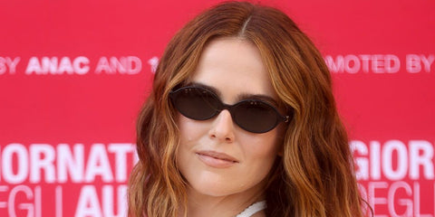 Zoey Deutch was seen wearing black Miu Miu MU 04ZS 1AB5S0 oval sunglasses at the Miu Miu Women's Tales during Venice Film Festival 2026.